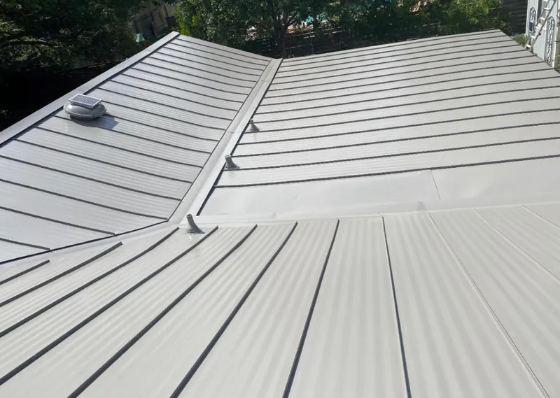 Solar attic fan installed on a metal roof for Roof Ventilation in Kearny